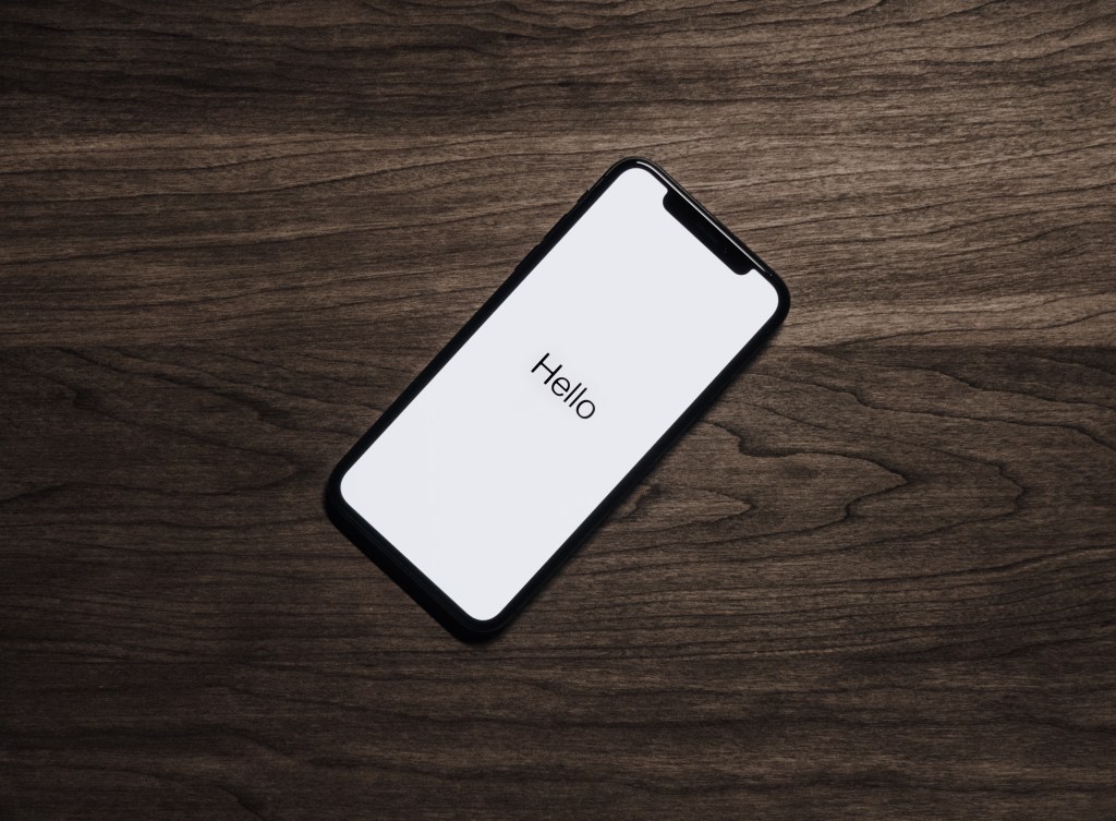 iphone x with hello on start screen on a wood kitchen table in san francisco california
